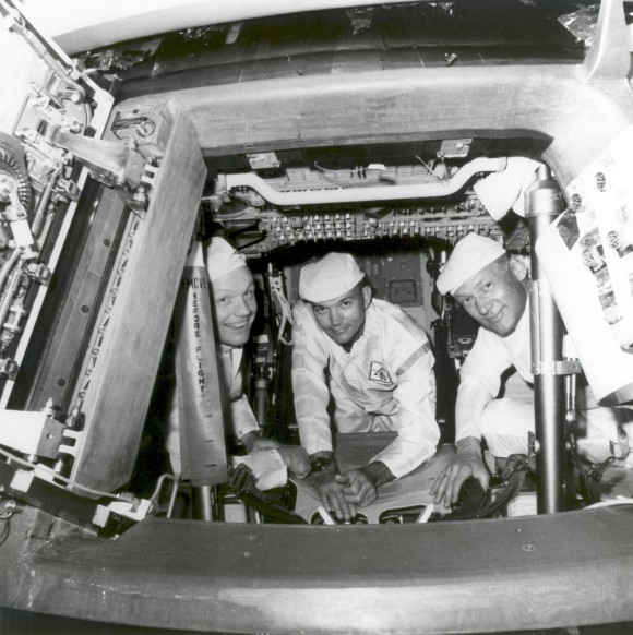 Armstrong, Collins and Aldrin conducing checks in the Command Module